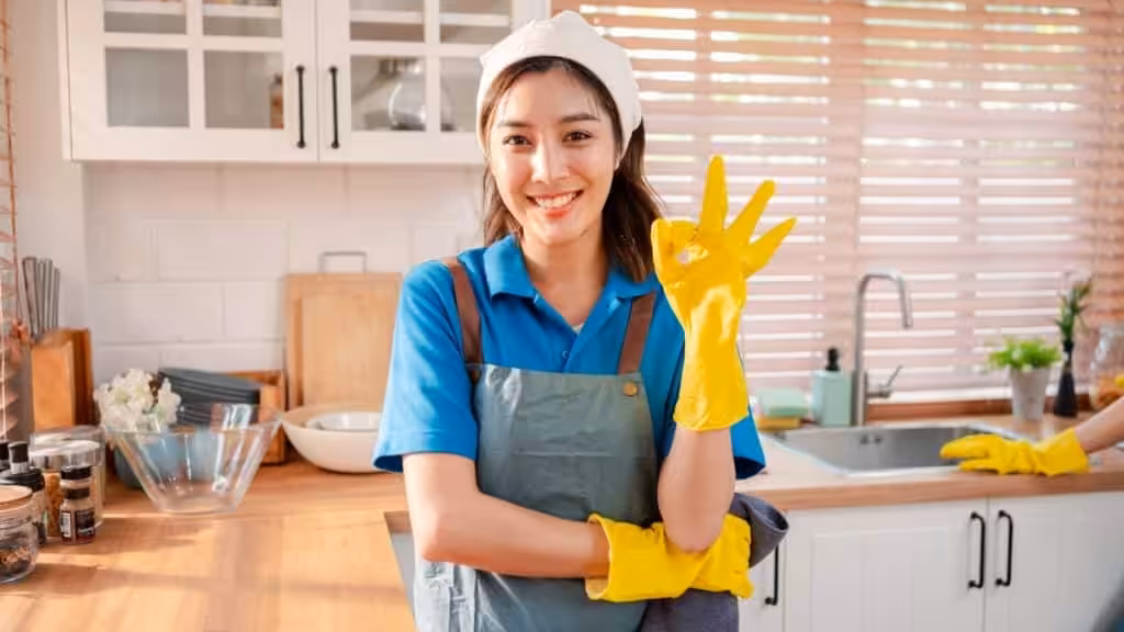 Residential cleaning team preparing a spotless kitchen with professional maid service.